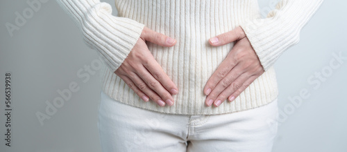 Woman holding her belly. Pregnancy, Reproductive system, menstruation, and gynecology concept