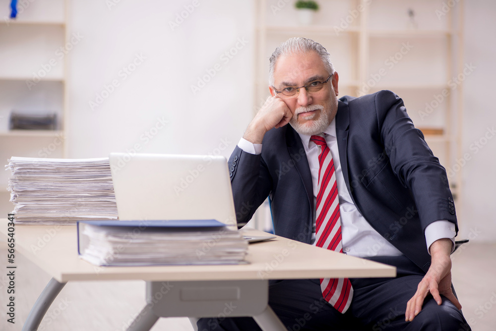 Old male employee and too much work at workplace Old male employee and too much work at workplace
