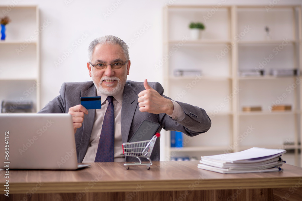 Old male employee in e-commerce concept Old male employee in e-commerce concept