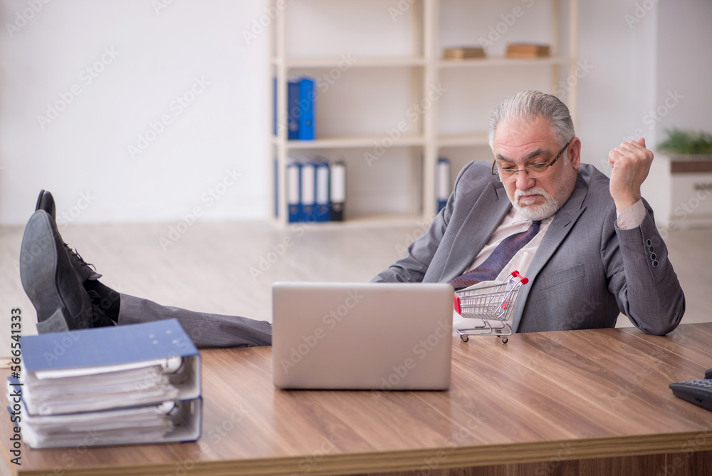 Old male employee in e-commerce concept Old male employee in e-commerce concept