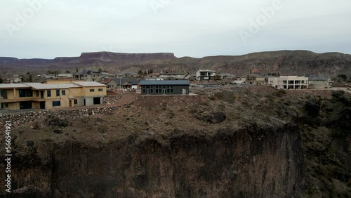 Houses on the edge of a cliff then ascending to reveal the southern Utah town of La Verkin photo