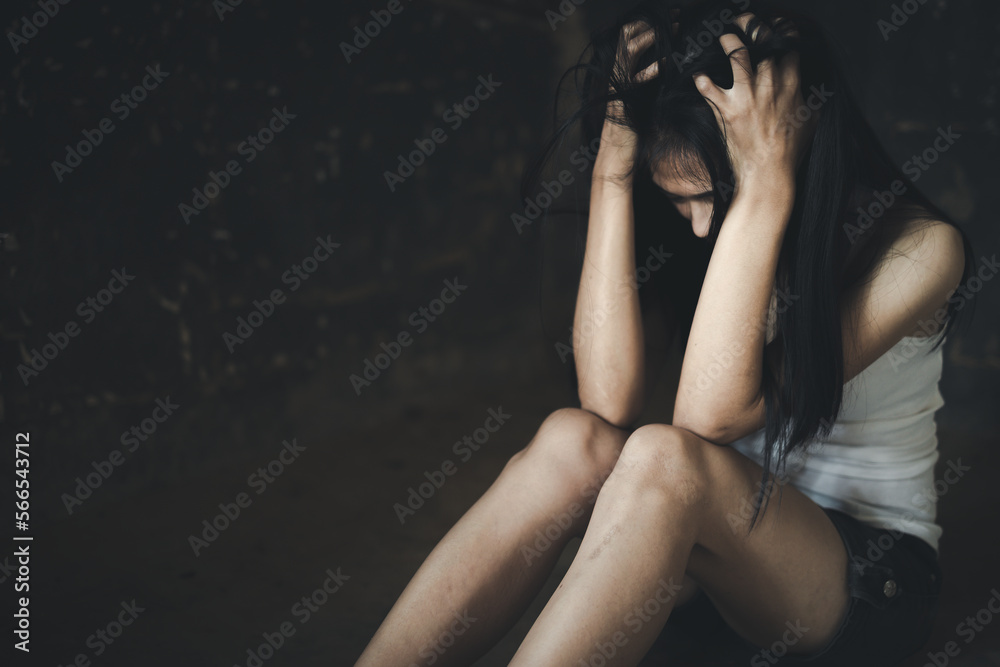 A woman hiding face. Violence against women concept. Depressed teenager sitting holding head in hands, stressed sad young woman having mental problems. A woman hiding face. Violence against women concept. Depressed teenager sitting holding head in hands, stressed sad young woman having mental problems.