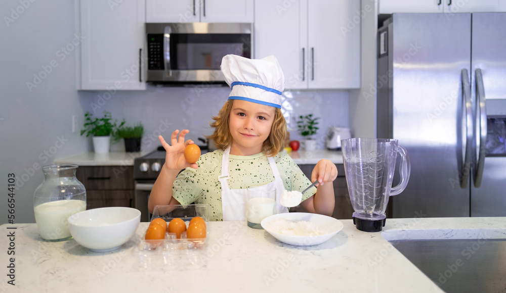Kid chef cook cookery. Cooking children. Child boy with apron and chef hat preparing a healthy meal in the kitchen. Cooking process. Kid chef cook cookery. Cooking children. Child boy with apron and chef hat preparing a healthy meal in the kitchen. Cooking process.