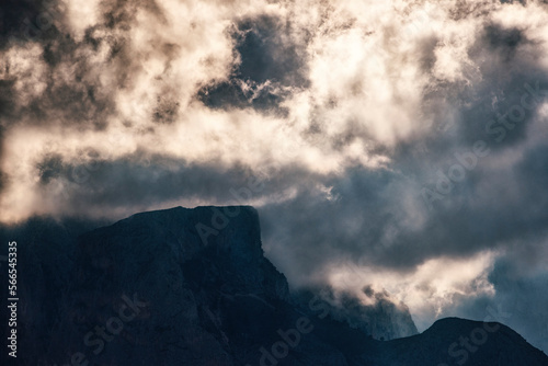 dramatic sky over rugged mountain silhouette