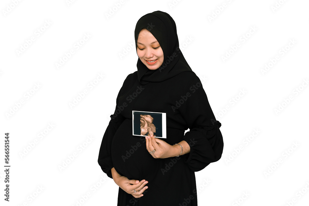 Happy Pregnant Young Hijab Woman holding showing ultrasound scan photo. Pregnant woman hands holding belly on white background. Happy Pregnant Young Hijab Woman holding showing ultrasound scan photo. Pregnant woman hands holding belly on white background.