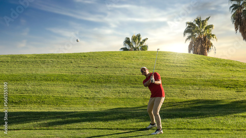 Fotografija Golfer shot the flagstick from the green at sunset on the golf course