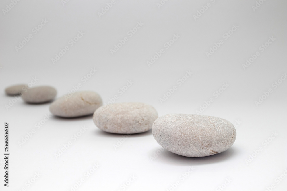 Row of smooth pebbles on white background Row of smooth pebbles on white background
