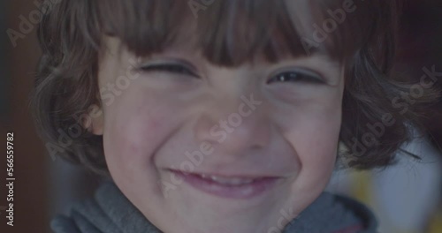 Cinematic close-up of 4-year-old Caucasian boy smiling at 4k camera. Slow Motion.
