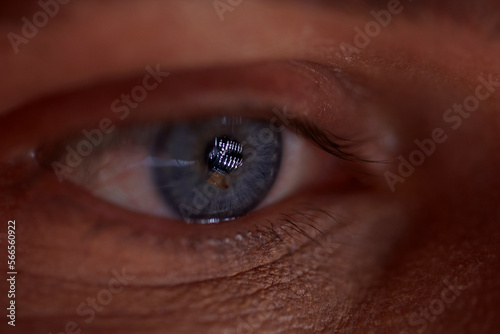 Close up of a female blue eye in studio lighting