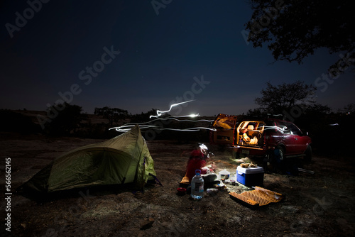 Armando Dattoli cooks dinner in his campsite at night in Caon de Aculco, Queretaro, Mexico. photo