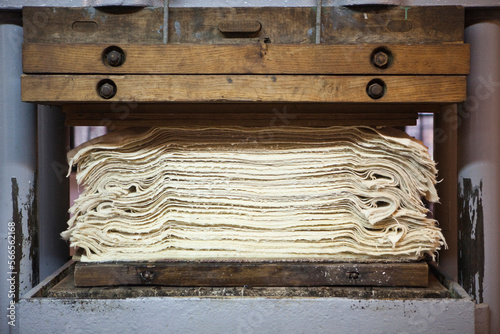 Freshly handmade paper is pressed to remove excess moisture at the historic Paper Mill in Duszniki-Zdroj, Poland. photo