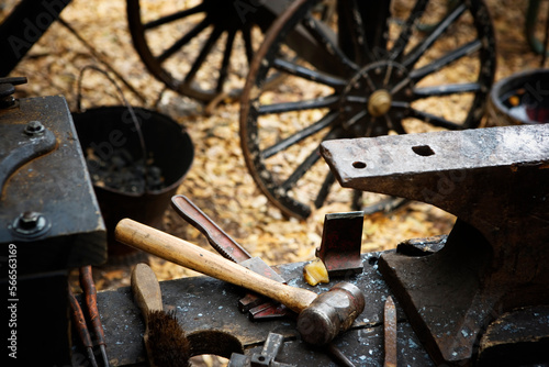 An anvil, hammer and tools in oldtime setting. photo