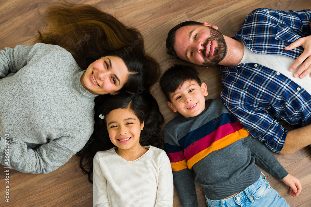 Happy family with children relaxing on the floor