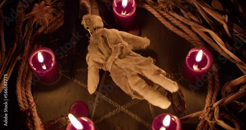 A voodoo ritual with a scary doll. Close-up shot.
