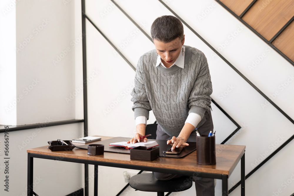 a woman in the office cleans up her desk a woman in the office cleans up her desk