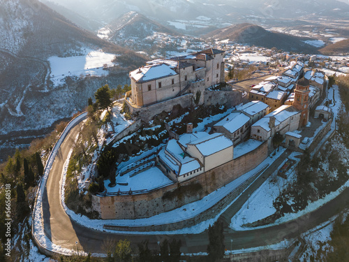 Italy, January 2023: aerial view of the medieval village of Frontone covered in snow. The village is located in the Marche region n the province of Pesaro and Urbino photo