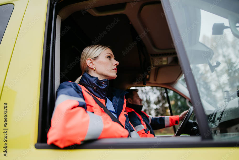 Obraz premium Portrait of young woman doctor sitting in ambulance car.