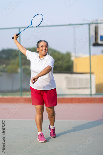 Senior Woman Playing Badminton in Outdoors. © G-images