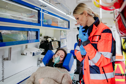 Rescuer taking care of patient, preparing her for transport.