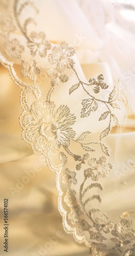 Background of soft bright satin fabric with lace from a wedding dress and veil