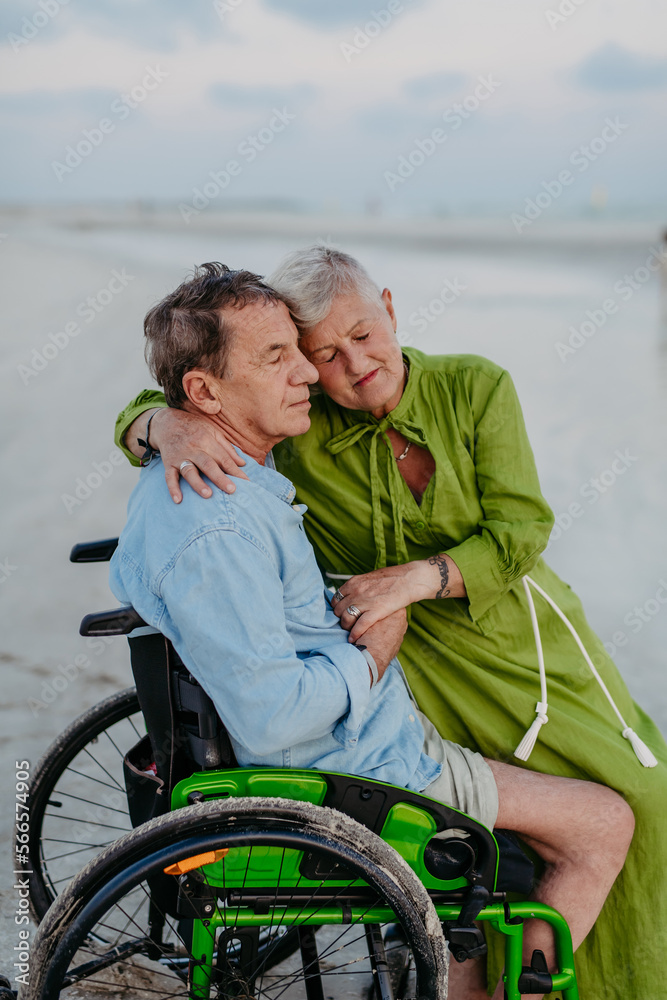 Senior man on wheelchair enjoying together time with his wife at sea. Senior man on wheelchair enjoying together time with his wife at sea.