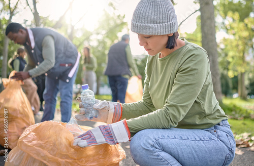 Trash, community volunteer and woman cleaning garbage pollution, waste product or team environment support. Plastic bottle container, NGO charity or eco friendly people help with nature park clean up