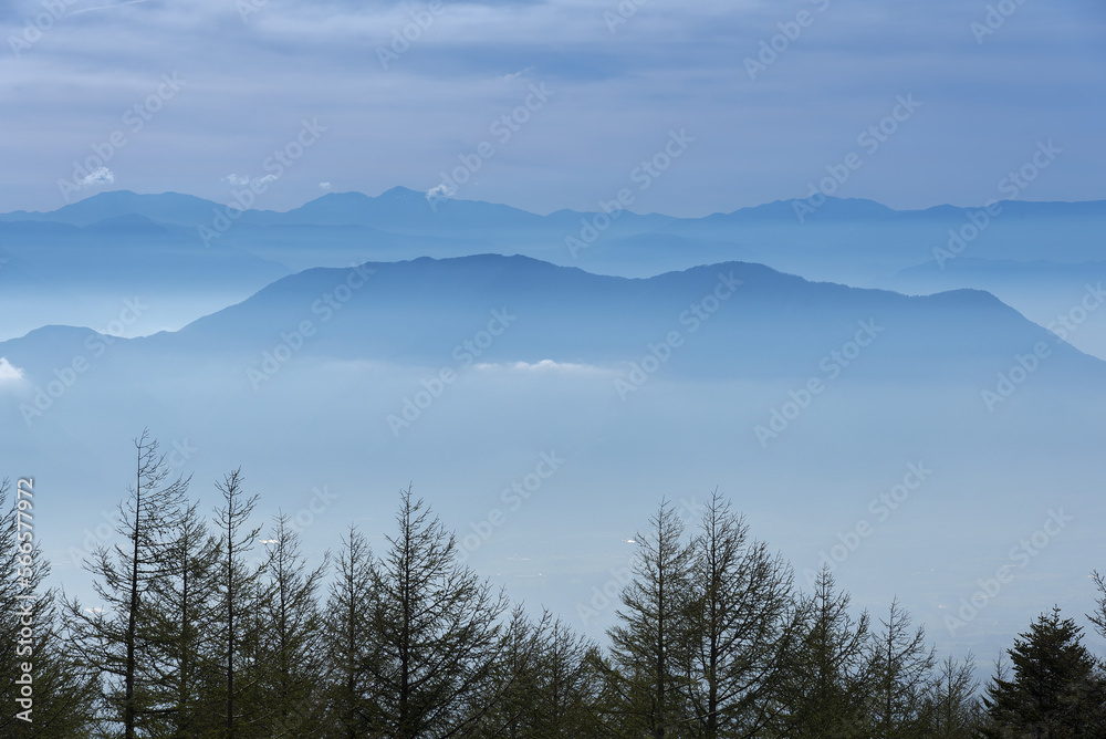 Japan mountain range in hazy blue sunshine.