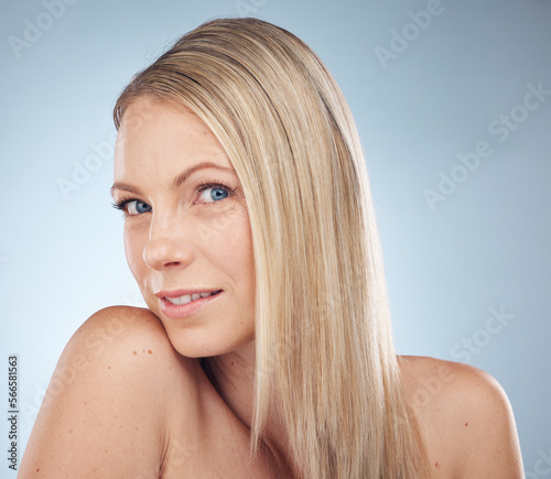 Skincare  makeup and portrait of a woman with hair care isolated on a blue background in a studio. Spa  wellness and cosmetology model with facial makeup  cosmetics and dermatology on a backdrop