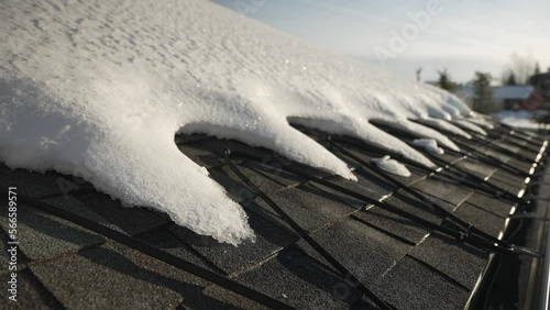 Winter heat cables on the edge of a roof melting snow