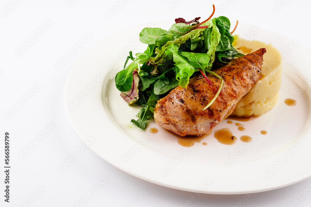 Baked chicken breast with mashed potatoes and arugula