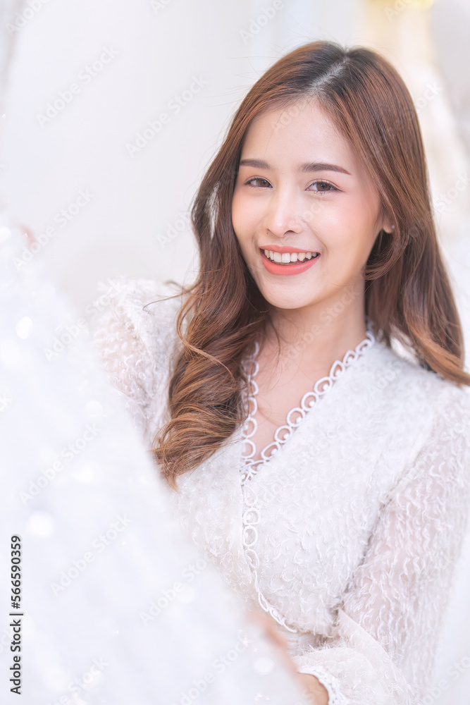 Women happy see many wedding dresses on shelf and in hands choose dresses for the wedding day Women happy see many wedding dresses on shelf and in hands choose dresses for the wedding day