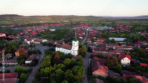 Aerial panorama of reformed protestant church in center of green village photo