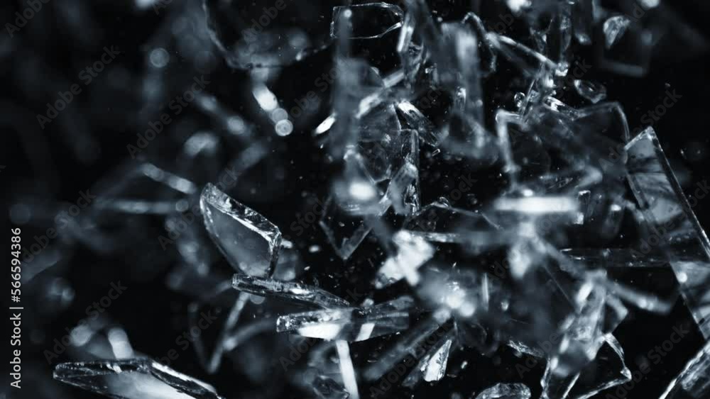 Super Slow Motion Shot of Shattering Glass Shards Flying Towards Camera on Black at 1000fps. Super Slow Motion Shot of Shattering Glass Shards Flying Towards Camera on Black at 1000fps.