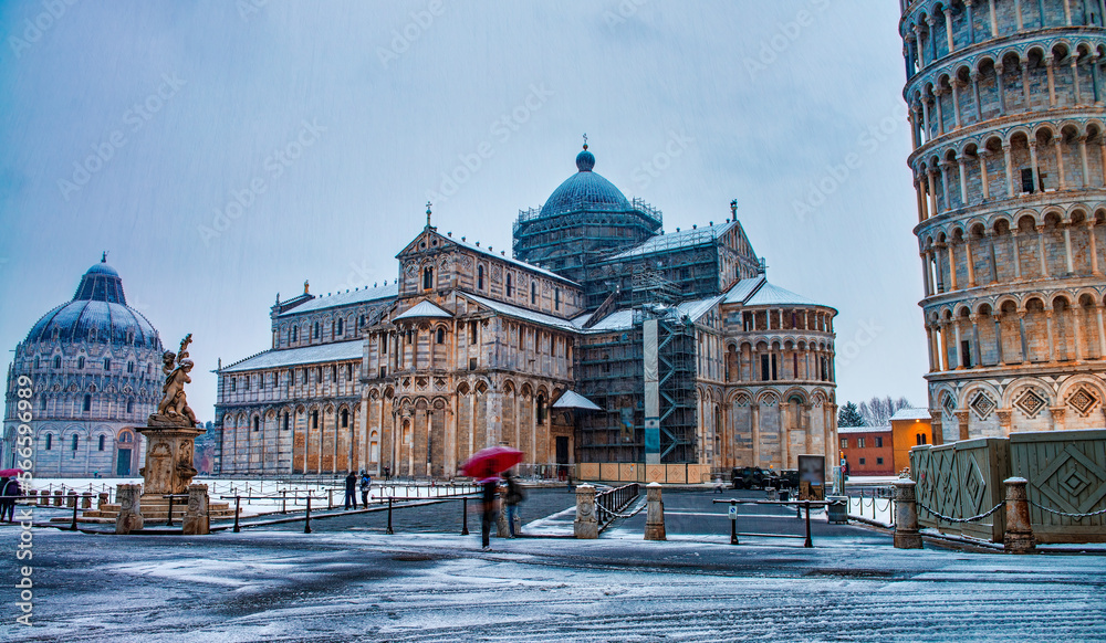 Fototapeta premium Pisa under the snow. Famous landmarks and monuments of Field of Miracles after a snowstorm
