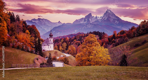 Stunning nature landscape. Incredible autumn scenery. Scenic mountain landscape in the Bavarian Alps. Small church on the highland. View on famous Maria Gern Church of Alps with colorful skt at sunset