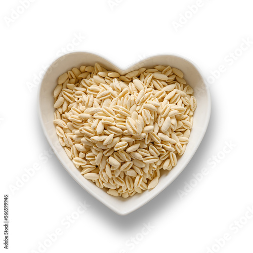 Dry pasta Cavatelli in white plate heart shape isolated on transparent or white background. View from above.
