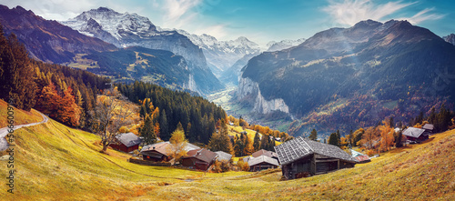 Wonderful Sunny landscape in Swiss alps. Wengen popular tourist village over the Lauterbrunnen valley, Switzerland. Europe. Concept of an ideal resting place. Creative image.