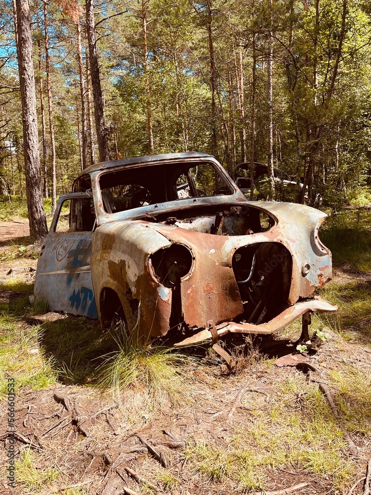 Old car in junkyard, abandoned vehicle in a car graveyard for automobiles Old car in junkyard, abandoned vehicle in a car graveyard for automobiles