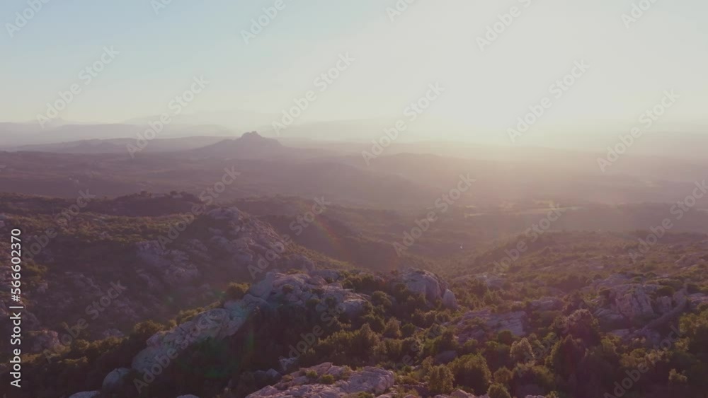Green countryside with rocky mountains at sunset Green countryside with rocky mountains at sunset