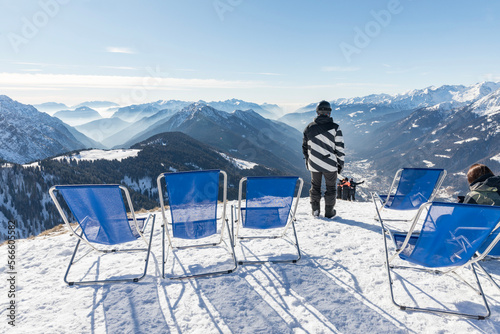 Sunbeds with a view of the Pinzolo valley. Inversion and fog over the ski area of Pinzolo (TN) Italy. A view from above of a fog-covered valley. Superski Dolomites, Italy. photo