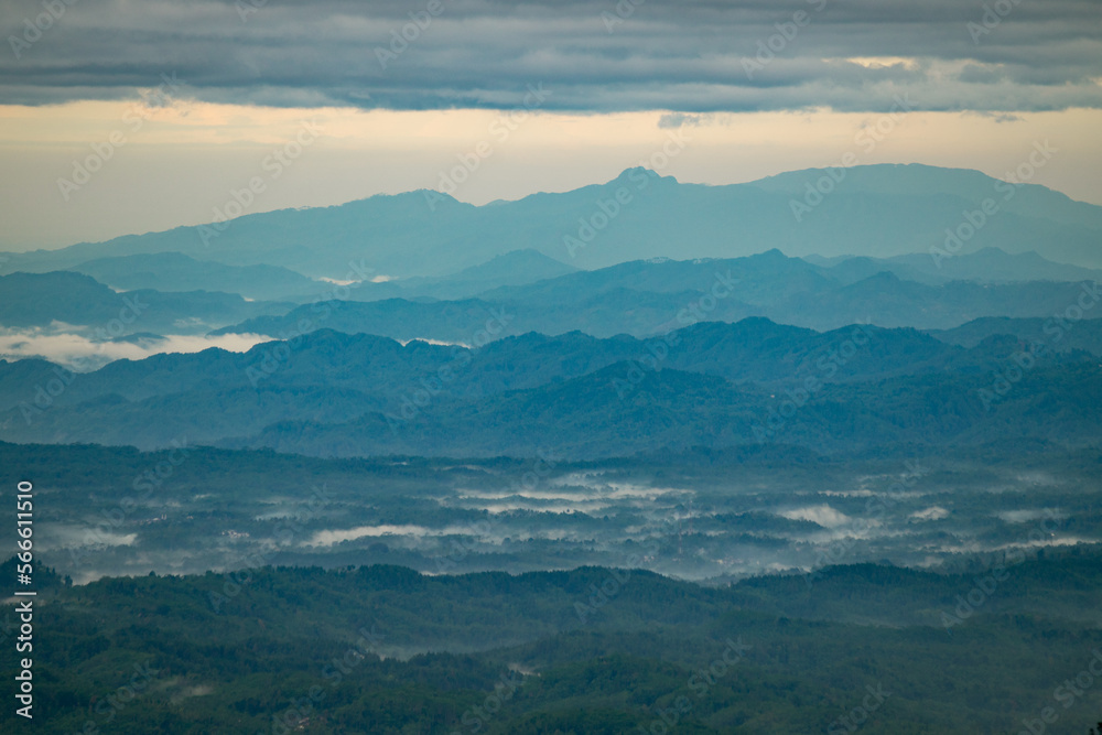 Layer of mountains at Central Java during sunrise and foggy condition Layer of mountains at Central Java during sunrise and foggy condition