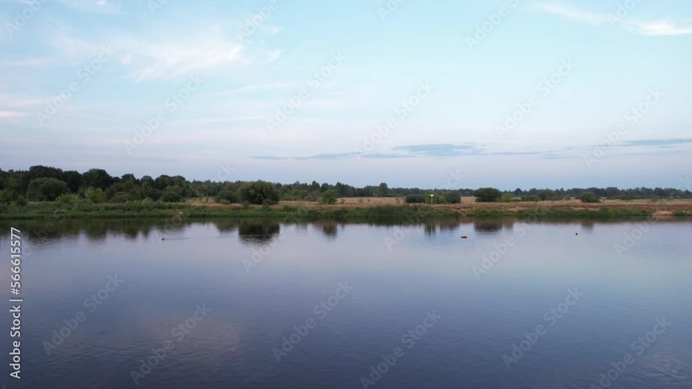Stunning aerial view of the river on a summer day with a forest on the banks and with cars of vacationers Stunning aerial view of the river on a summer day with a forest on the banks and with cars of vacationers