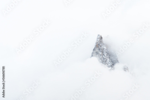 peak out of fog in snow and blizzard
