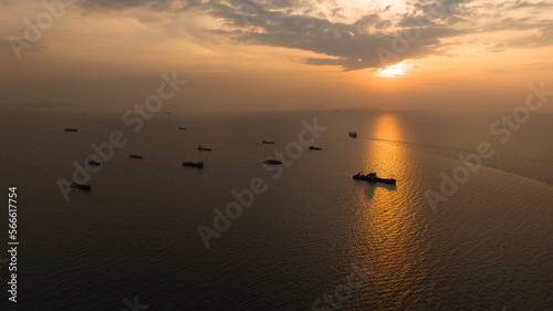 Fototapeta Naklejka Na Ścianę i Meble -  Seascape and silhouette container ship floating in sea and over the sunlight background,