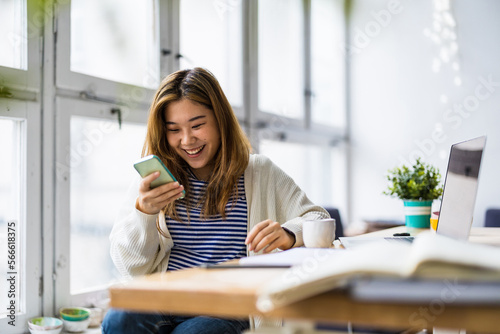 Young woman using smartphone in loft office

