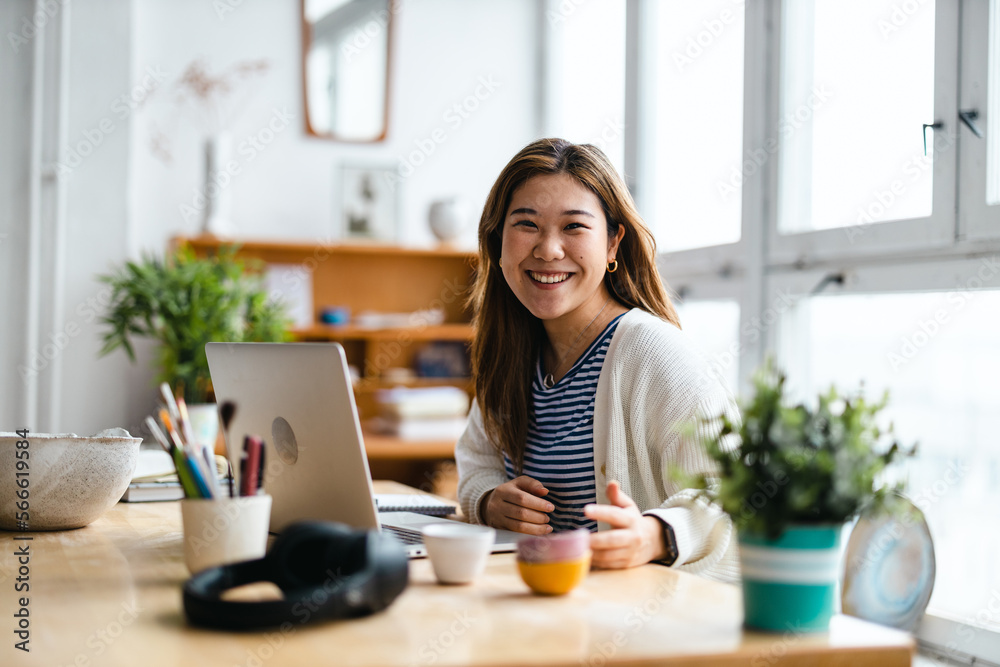 Young woman sitting at desk working on laptop
