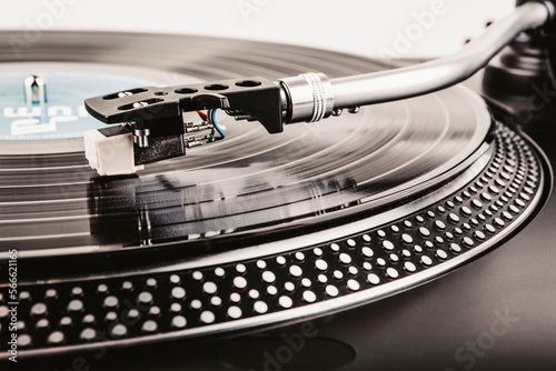 Playing a vinyl record on a turntable photo