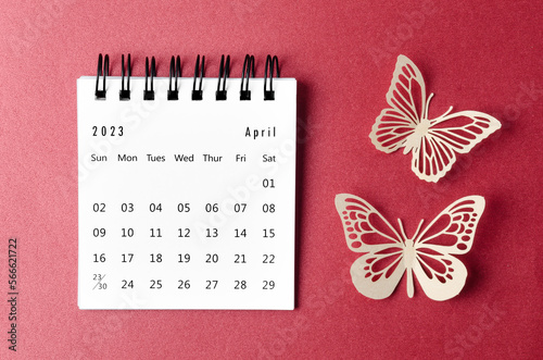 The April 2023 desk calendar for the organizer to plan and reminder with paer butterfly on red background. photo