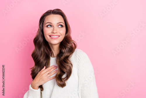 Portrait of lovely cute lady beaming smile hand touch chest look empty space isolated on pink color background © deagreez