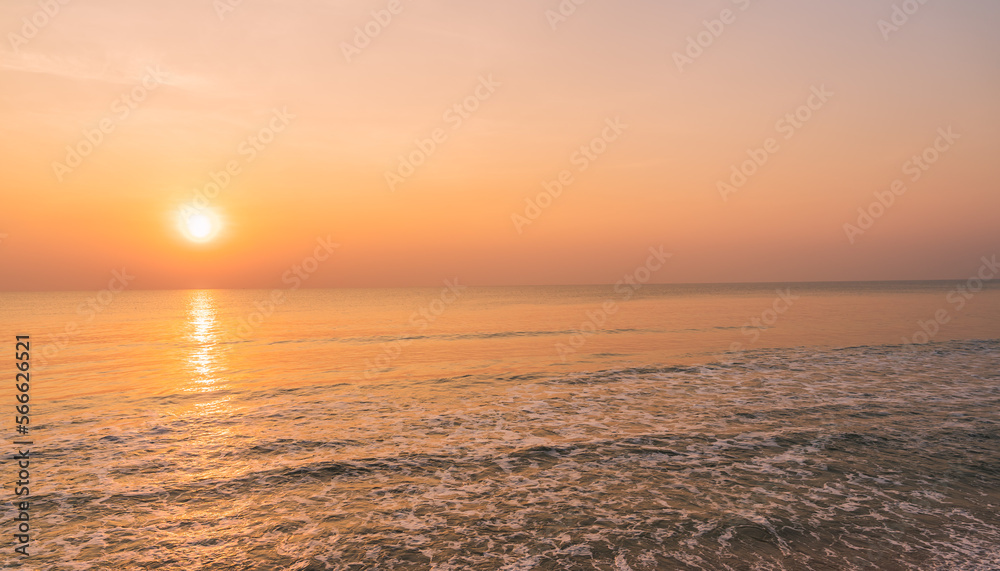 Sunset sky over sea in the morning with orange, red, pink sunrise 